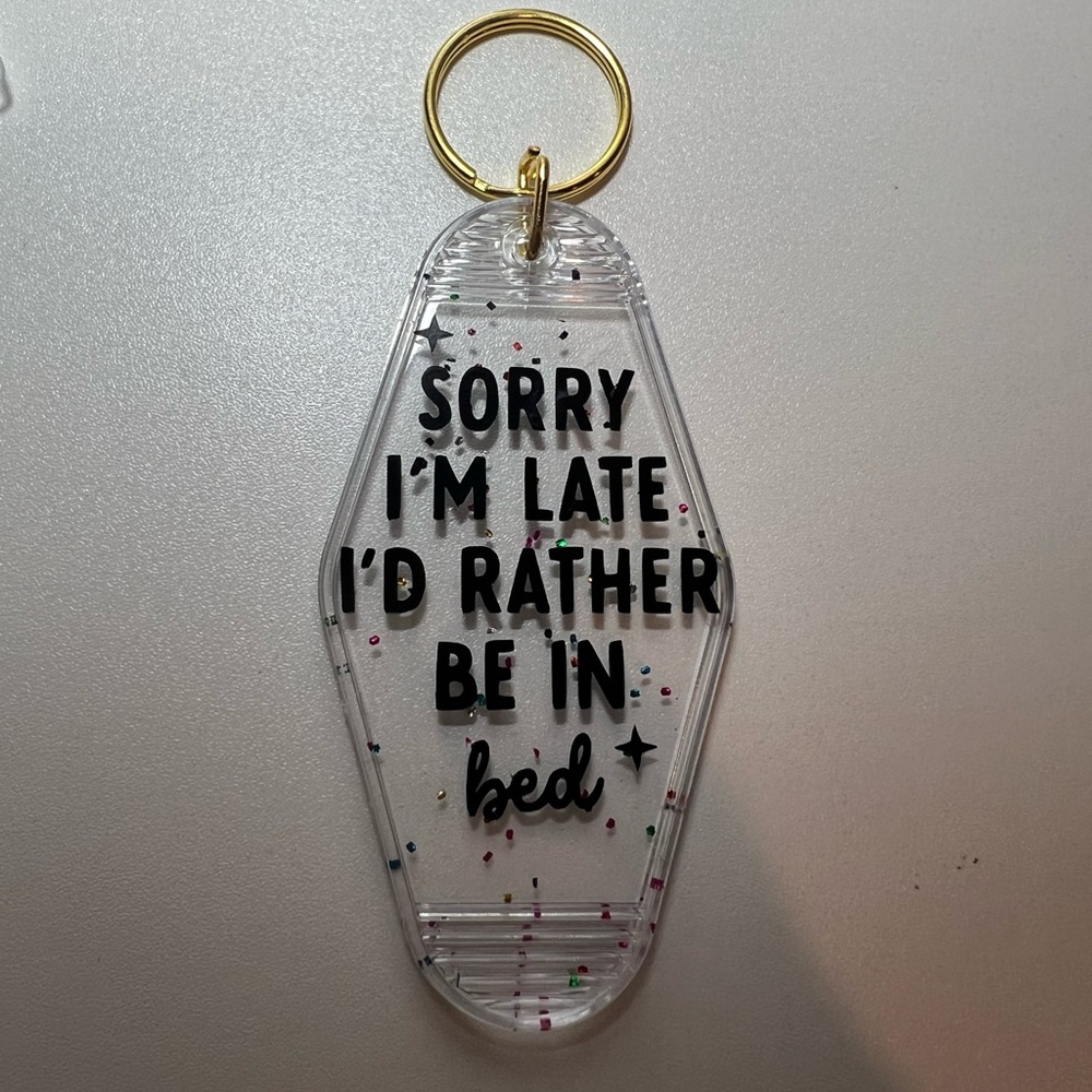 “Sorry I’m Late I’d Rather Be In Bed” keychain with confetti/sparkle background